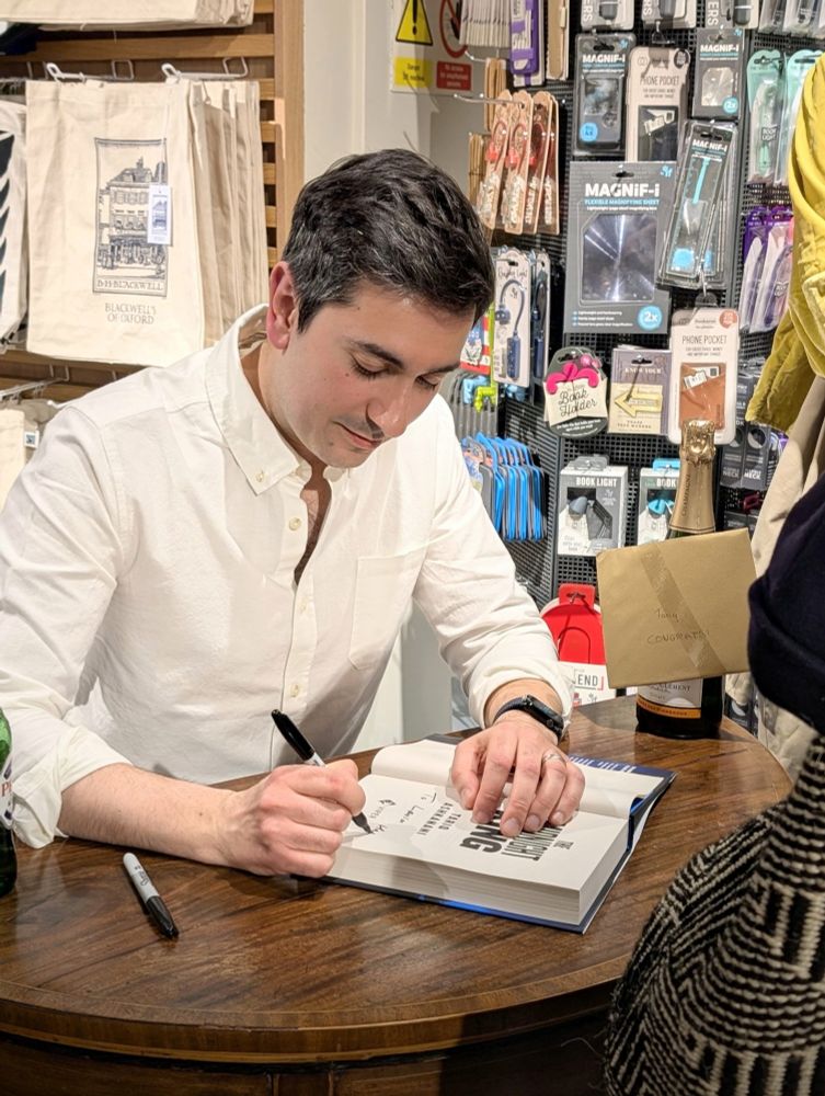 Tariq signing a copy of The Midnight King at his launch