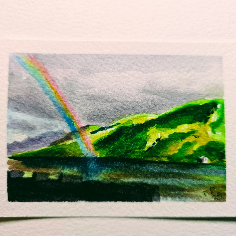Small watercolor painting of a rainbow over Kylemore Lough and the Connemara landscape in Cou ty Galway, Ireland