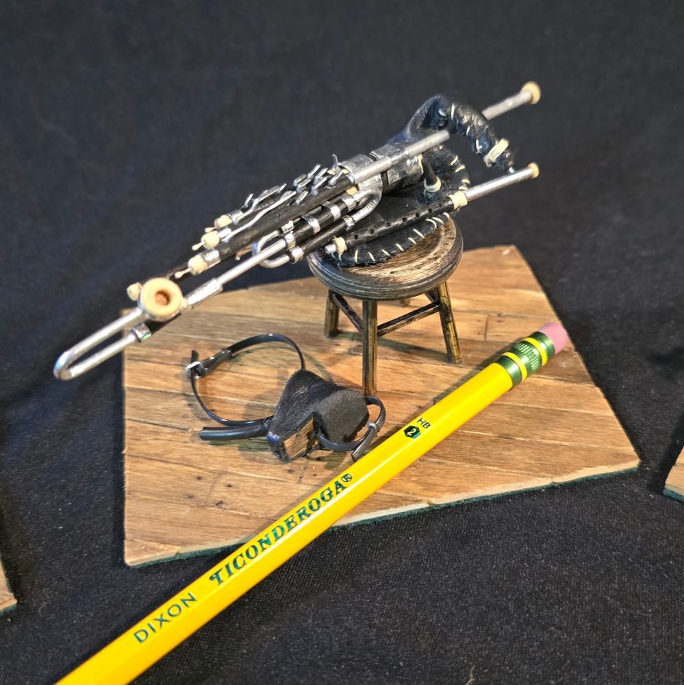 Miniature set of uilleann pipes (irish bagpipes). Pencil shown for scale, but pipes have an overall length of about 5 inches.