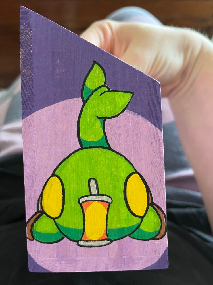 The front face of a tonberry laying on the ground staring at its lantern.