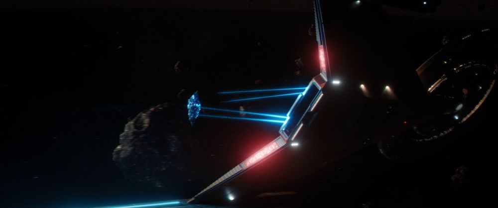 The Discovery launching an asteroid out of its shuttle bay, and grabbing it with a tractor beam, in a screenshot from New Eden.