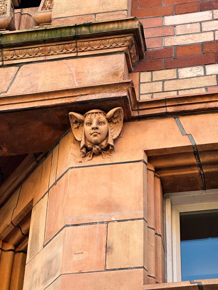 Detail on a terracotta building. A female face.