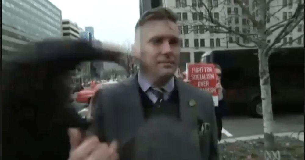 Formerly famous alt-right dweeb Richard Spencer, right at the moment where an anonymous person's fist strikes his punchable face.