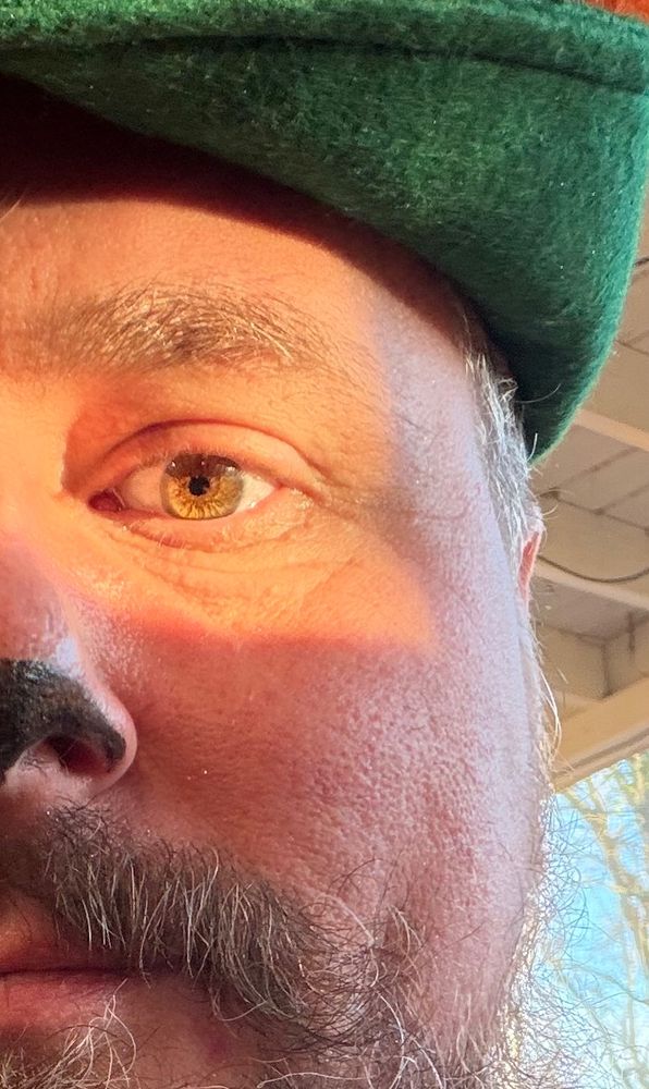 Close up of half of somebody’s face being a quarter lit by magic hour lighting 