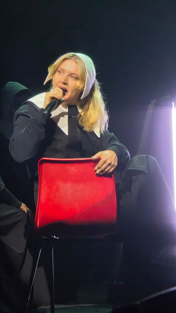 Self Esteem still looking a little misty-eyed a couple of songs later while sitting on a plastic chair