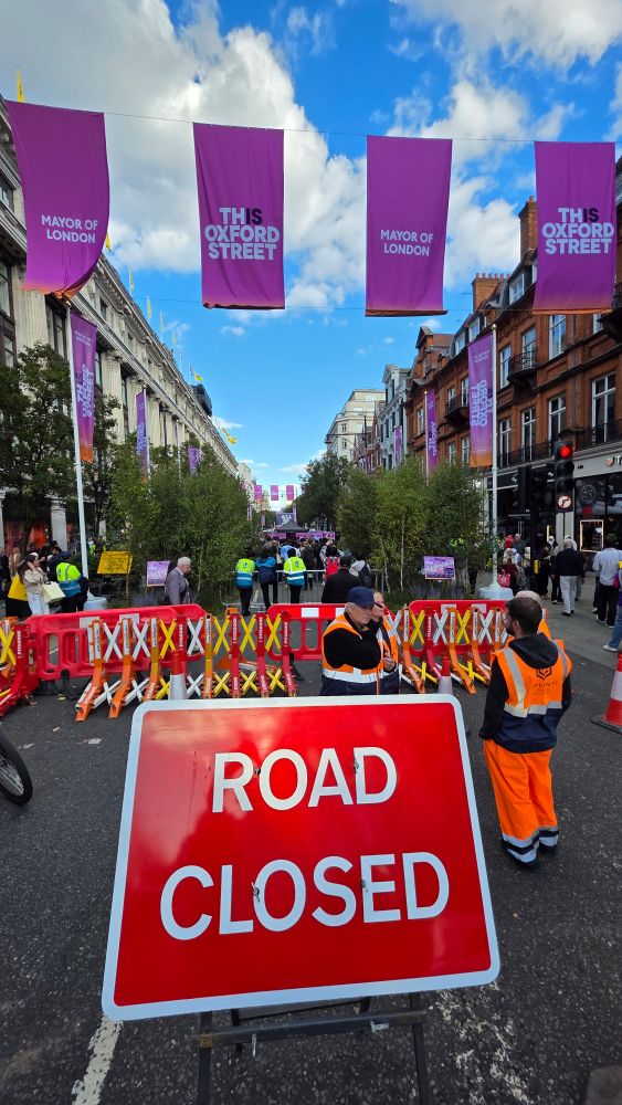 A big "Road Closed" sign blocking Oxford Street, with Kojey Radical's performance happening just beyond