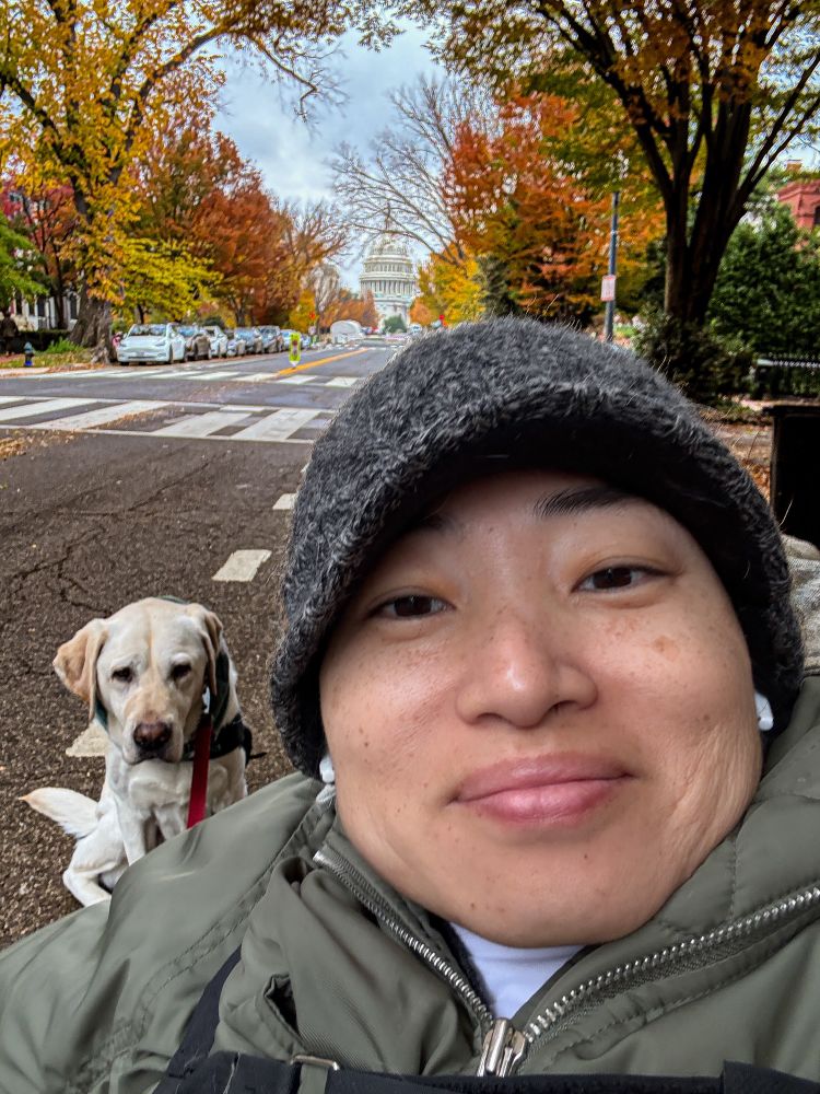 Photo of me and Zini. In the background is the Capital dome surrounded by trees covered in colorful fall leaves. 