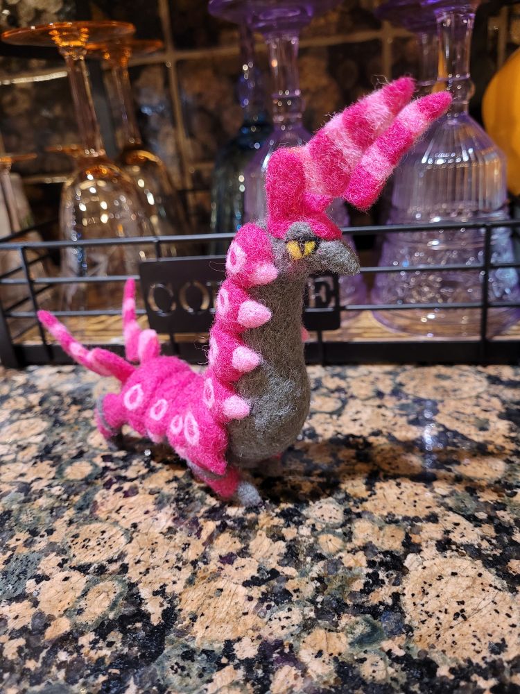 a needle felted scolipede facing right