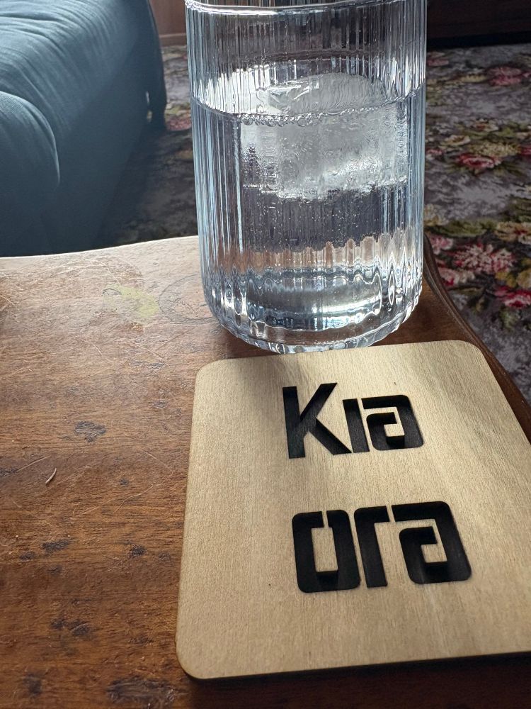Gin and tonic next to a coaster that says Kia Ora made by our BlueSky mate LostArcNZ 
