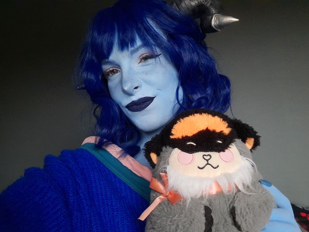 Me in my Jester cosplay, with the official CR Mister plush in my hand. 