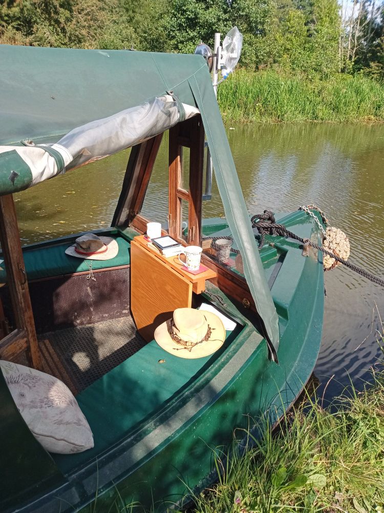 Looking down into the sunny we'll deck of the Erica. Teas, hats cushions, and books are out and ready for a relaxed Sunday morning.