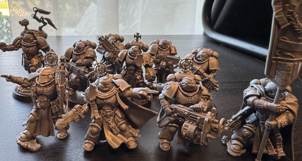 a collection of freshly assembled space marines: an apothecary biologis, five sternguard with bolters, and 4/5ths of a company heroes squad (I already have a painted company champion)