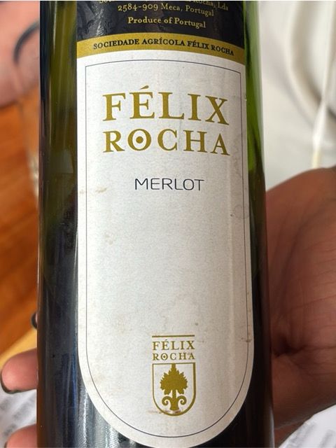 A bottle of red wine - the name on the off-white label is ‘Felix Rocha’