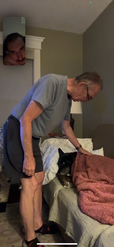 My dad tucking in my dog because the AC was too cold. 