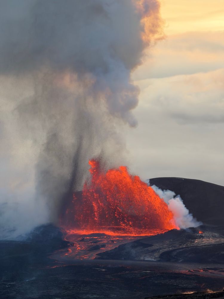 erupting volcano with lots of lava and smoke