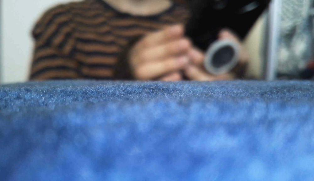 Picture of sprite from far away, typing on his phone. 
