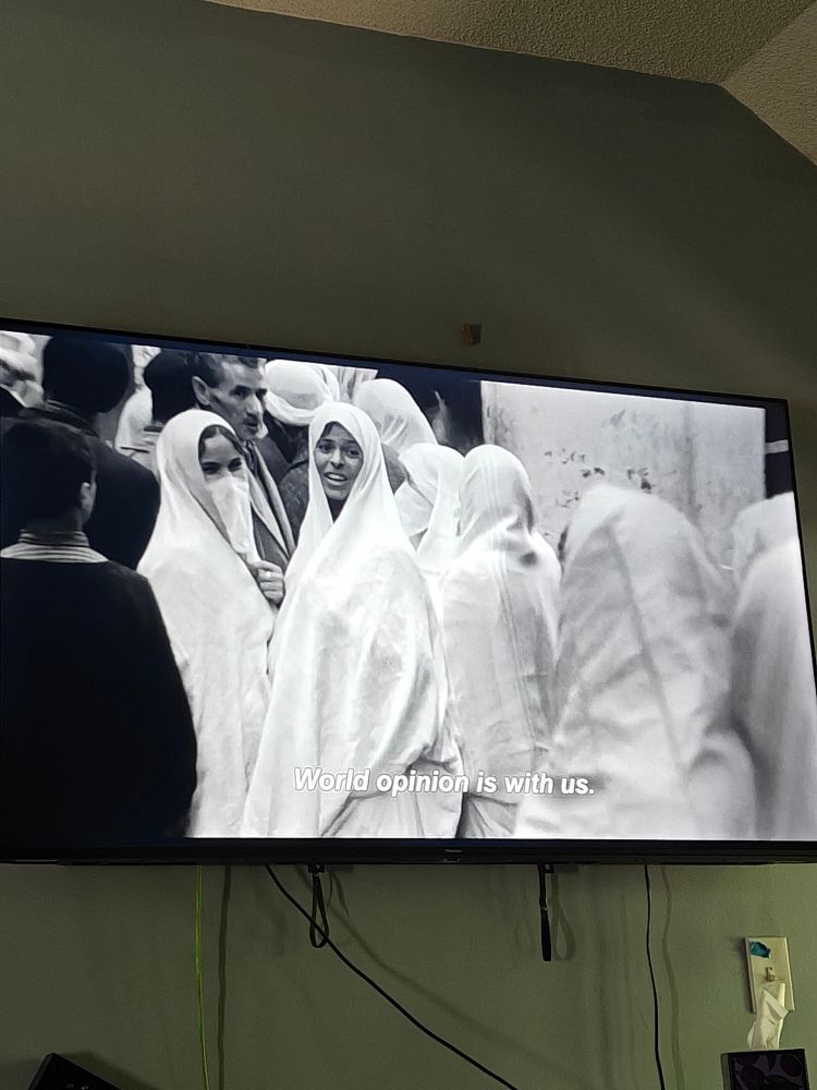 A photo of my television of the Battle of Algiers. The subtitle says "World opinion is with us." 
