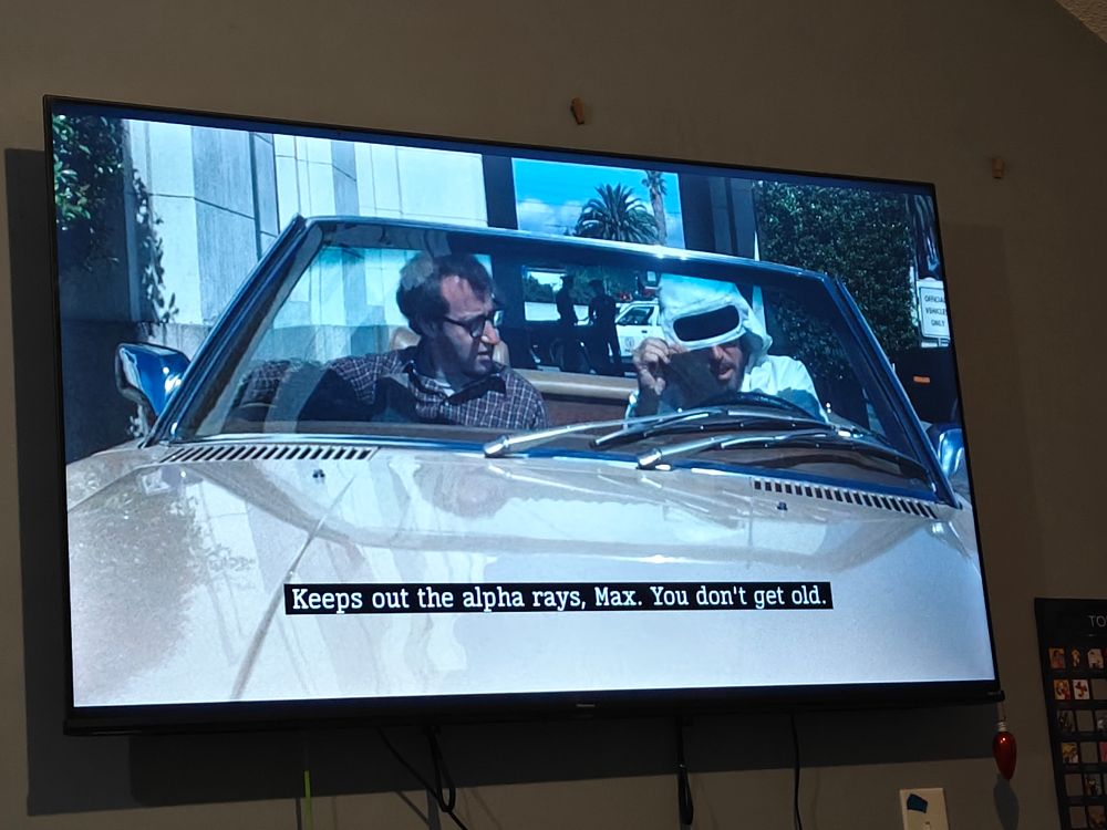 A shot of my television of Annie Hall. The subtitle says "Keeps out the alpha rays, Max. You don't get old." 