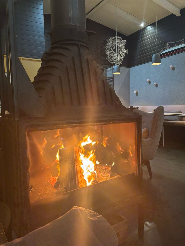 The enclosed fireplace with blazing logs at South of Johnson. 
