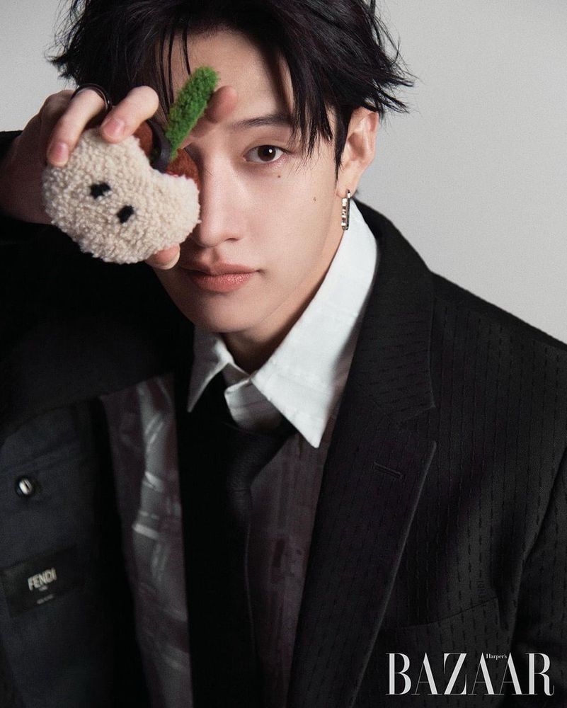 Chan holding an apple plushie near his eye