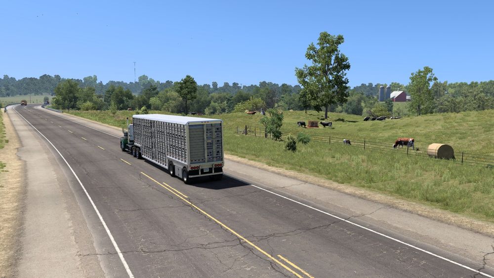 American Truck Simulator screenshot of my Kenworth W900 driving through some beautiful farmland along Route 136.