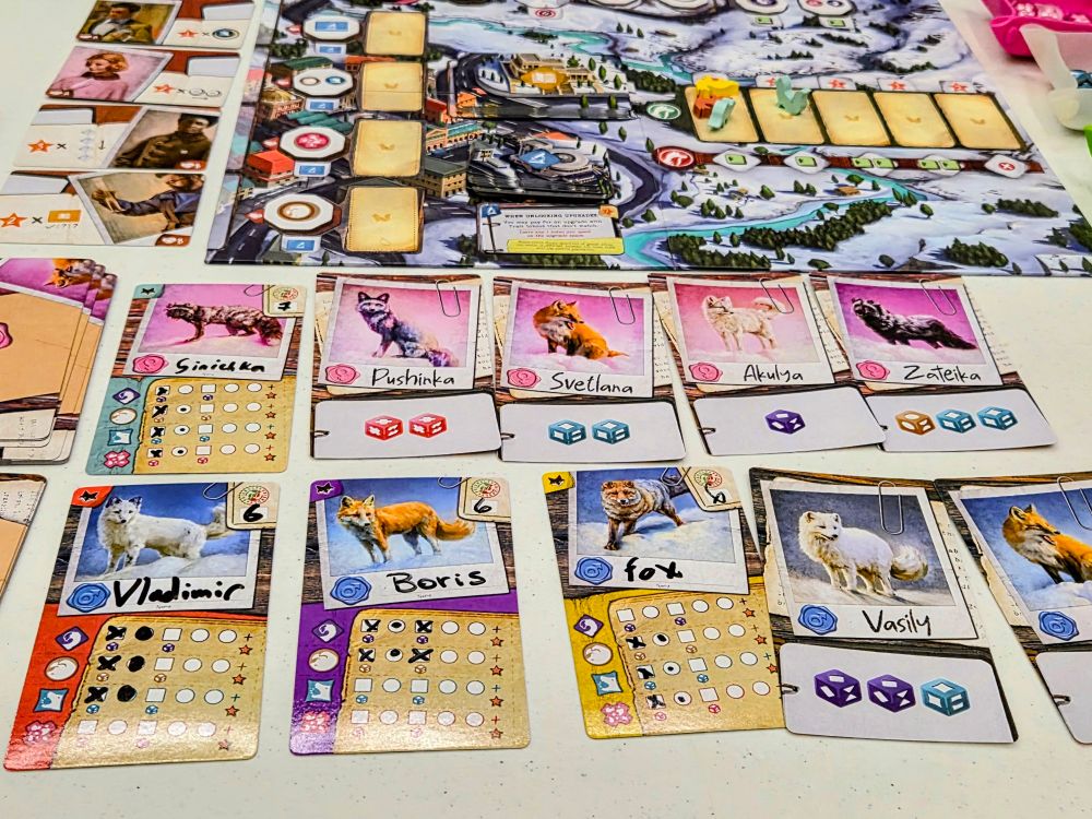 The main player area with cards with listed traits, some marked off with an X. The main board is above.