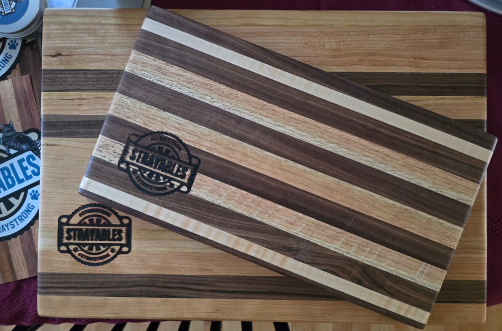beautiful hand made wood cutting boards small and large with two tone wood stripes, branded with the Strayables logo