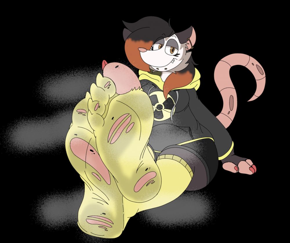 Dark haired possum girl with orange highlights sporting a black and yellow radiation logo hoodie, black shorts and tattered dirty yellow socks. She is showing off her smelly socked feet.