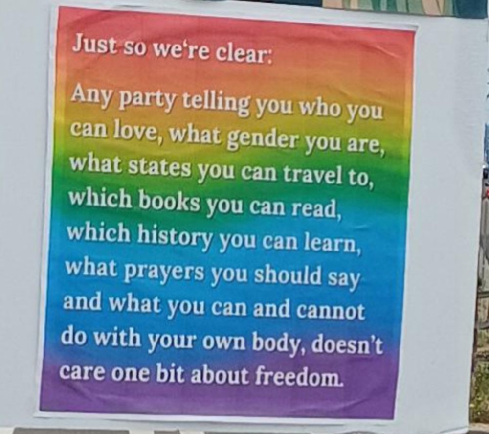 Text overlay on a rainbow background: 