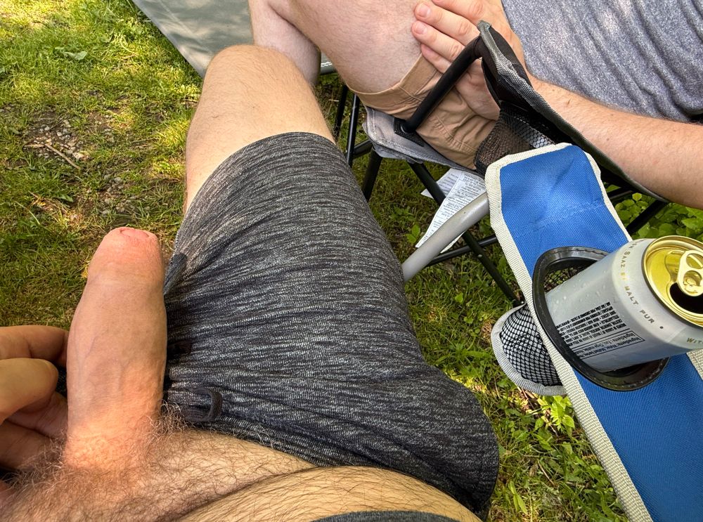 Pic of my POV of my semi hard cock hanging out of sweat shorts while I sit in a camping chair and drink a beer. My man is next to me (he took care of me after this)