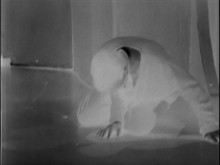 Ian collapsed on the ground in photo-negative.