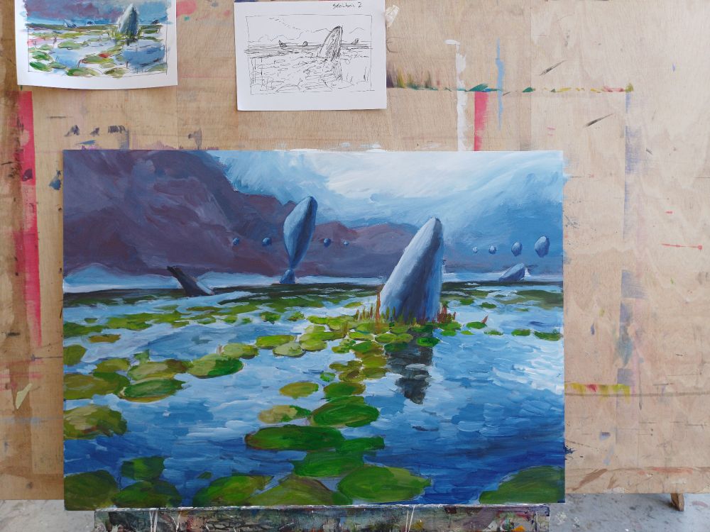 Painting on an easel, we see a stone in a lake full of waterlilies a stormy sky, floating rocks in the bg. Some sketches above the painting. 