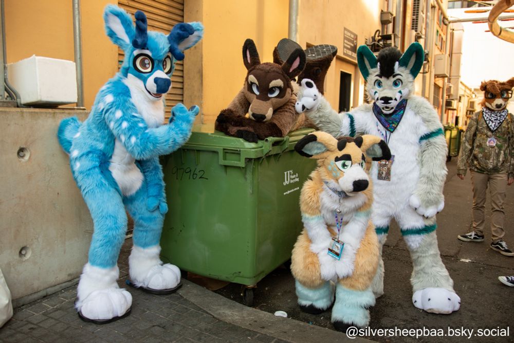 Furry trash, no, furry treasure. (Five deer or deer hybrid fursuiters posing with a skip bin)