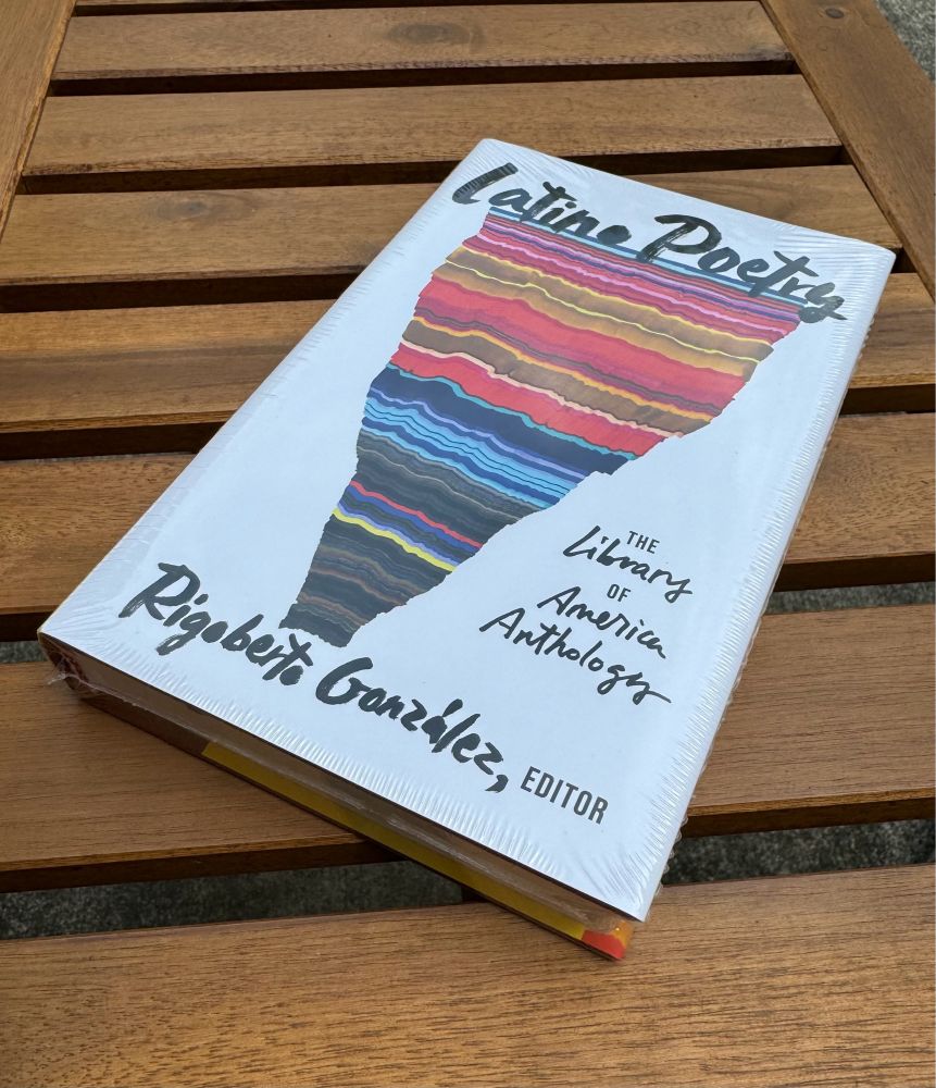 Photo of the book “Latino Poetry: the Library of America Anthology,” showing its colorful cover art.