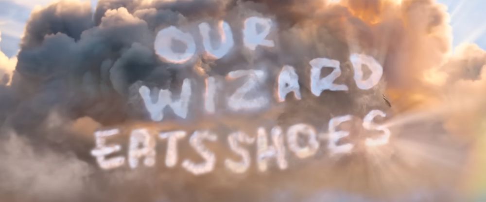 A cloudy sky, with cloud formations that look like words, reading: "Our wizard eats shoes" in reference to the "Our wizard lies" Wicked trailer scene that was revealed recently. Did you know that Dorothy's last name is Gale? Maybe they're related.