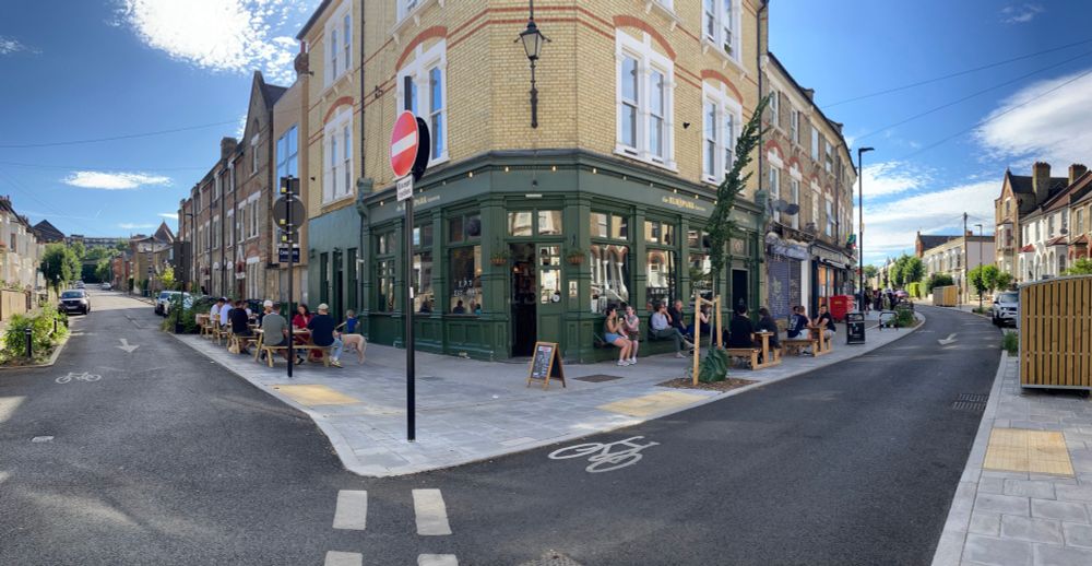 Elm Park Tavern on a sunny afternoon with people enjoying themselves outside and nearby 