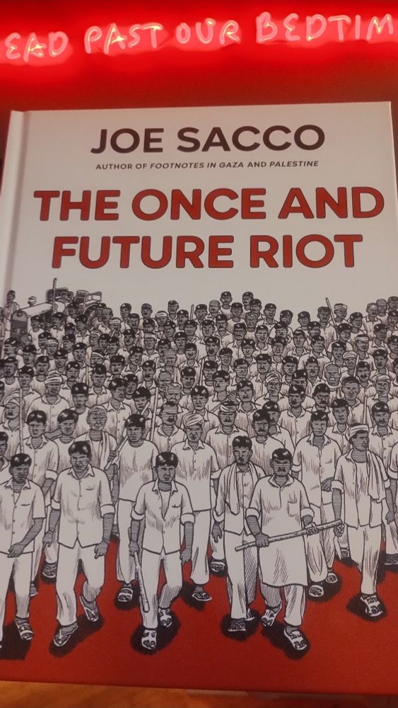 Hardback graphic reportage The Once & Future Riot, showing a menacing group of men walking towards the viewer 