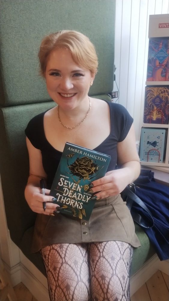Author Amber Hamilton with her new novel, Seven Deadly Thorns, in the Edinburgh Bookshop 
