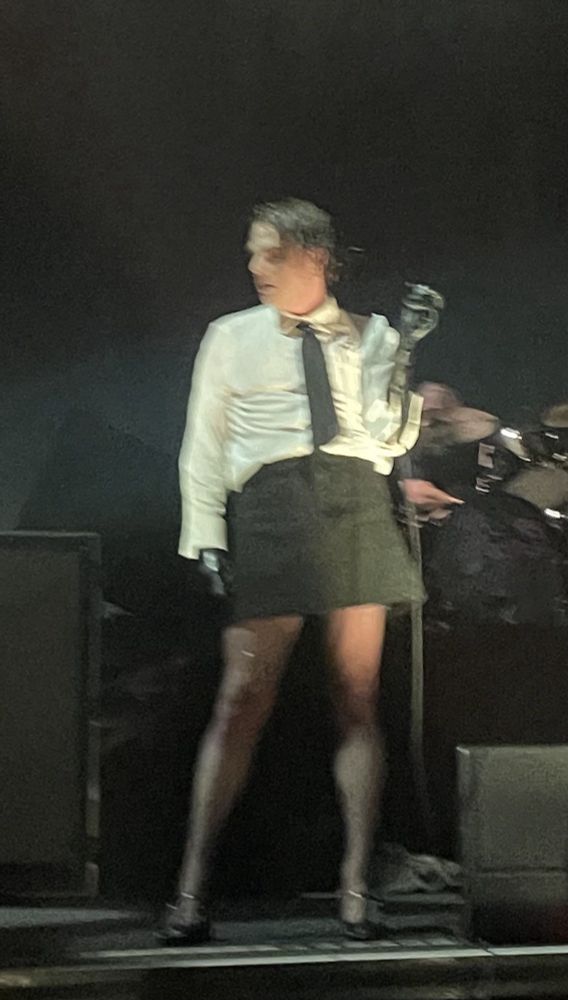 gerard way in a skirt with a white shirt and tie and black tights