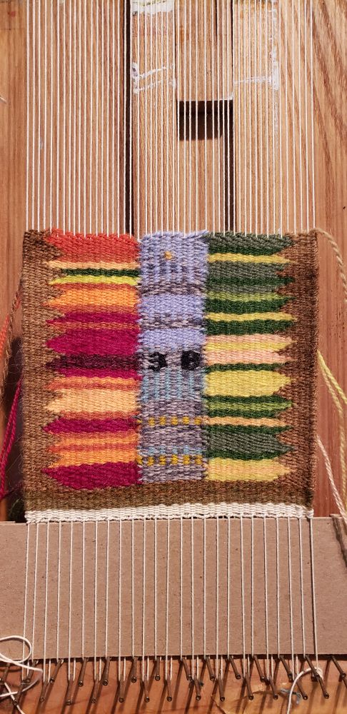 multi-colored handwoven tapestry on frame loom