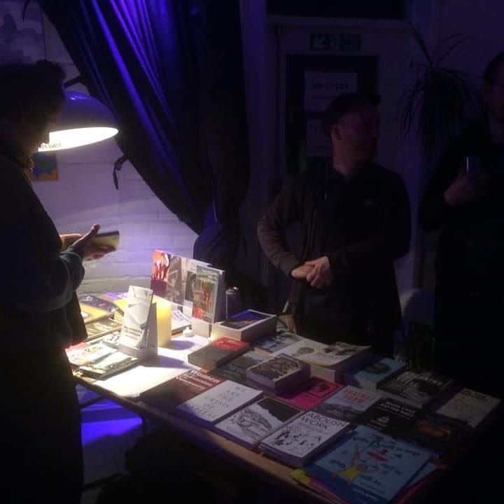 A bookstall in a dimly lit venue.