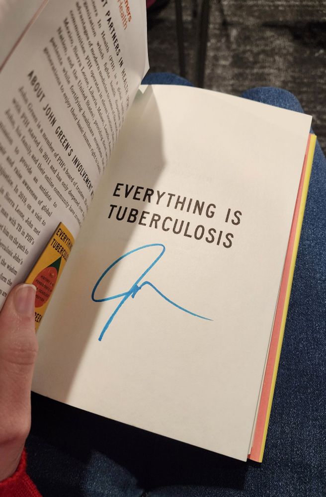 The title page of a copy of Everything is Tuberculosis with a light blue signature below the title