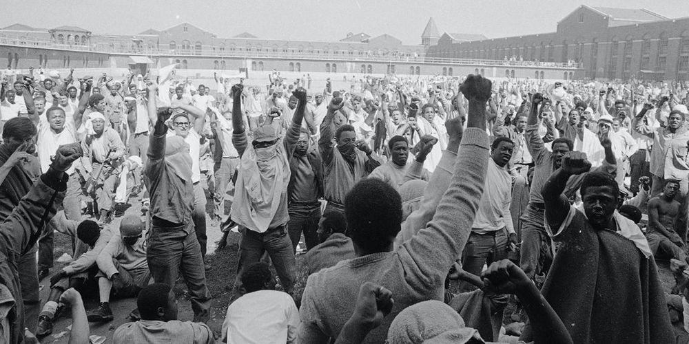 group of Black political prisoners raising their fists together