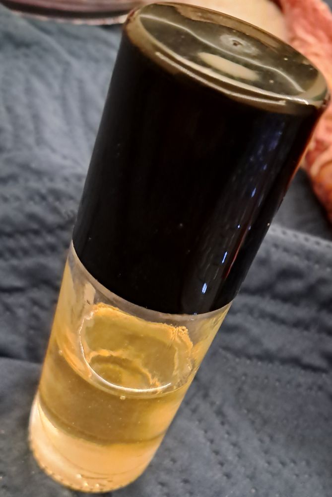 roll-on body oil with a black lid