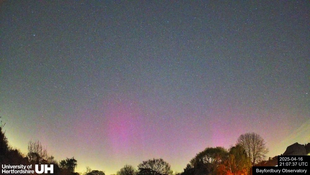 Another image of the Aurora, with stronger purple curtains visible across the sky 