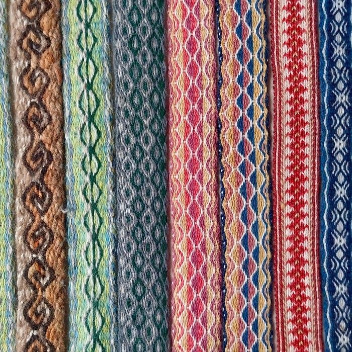 A variety of tablet-woven patterns in various colours. Many are intricate patterns of diamonds and swirls.