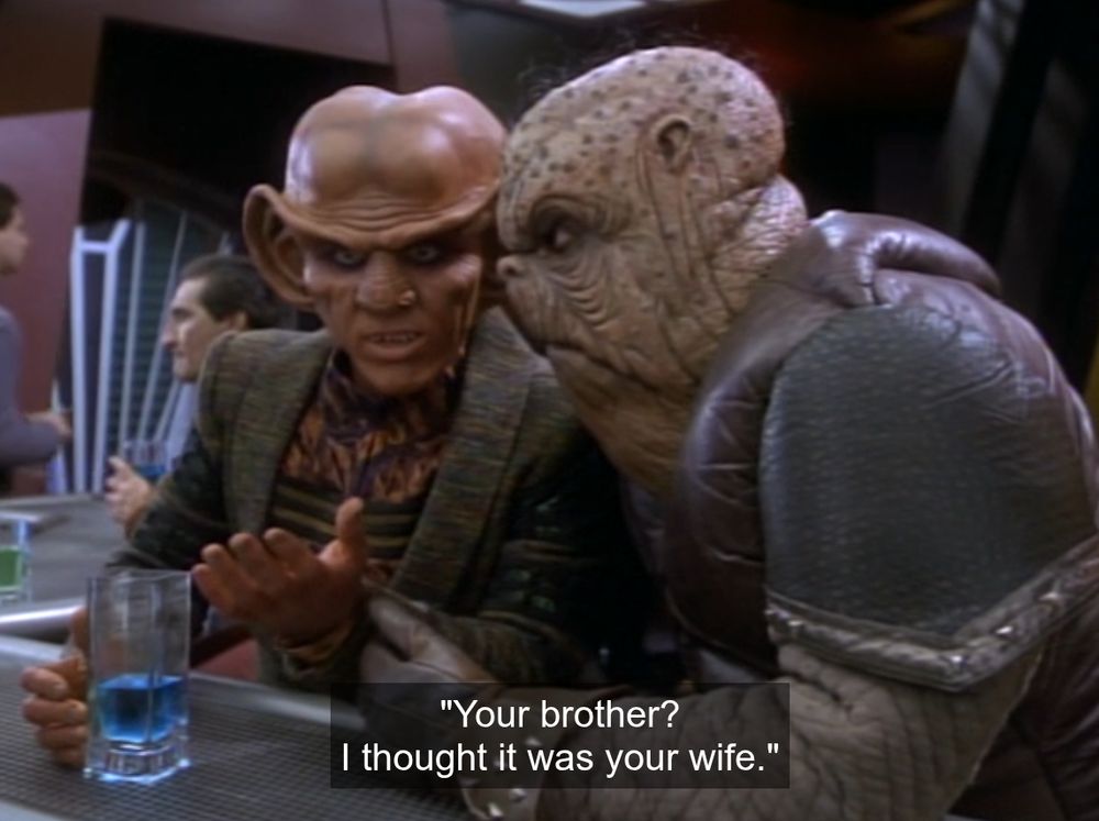 Quark explaining a joke to Morn, with the caption "Your Brother? I thought it was your wife."