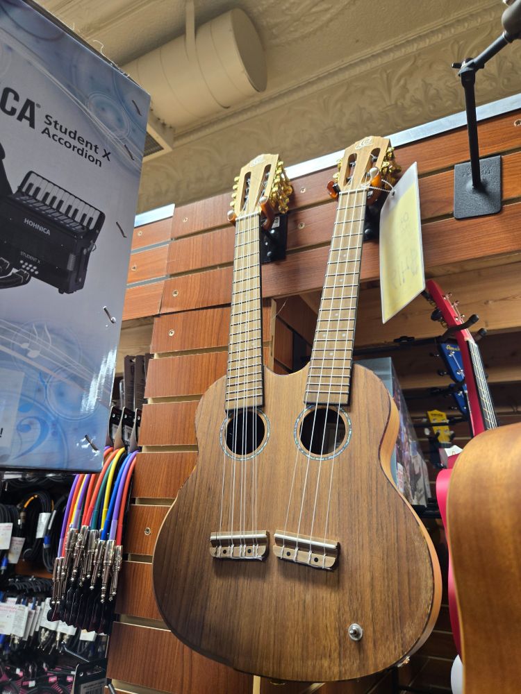Odd ukulele on a music store wall 