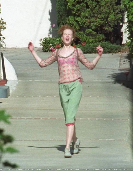 Image of the famous Nicole Kidman picture where she looks relieved and happy leaving her attorney’s office after signing her divorce from Tom Cruise