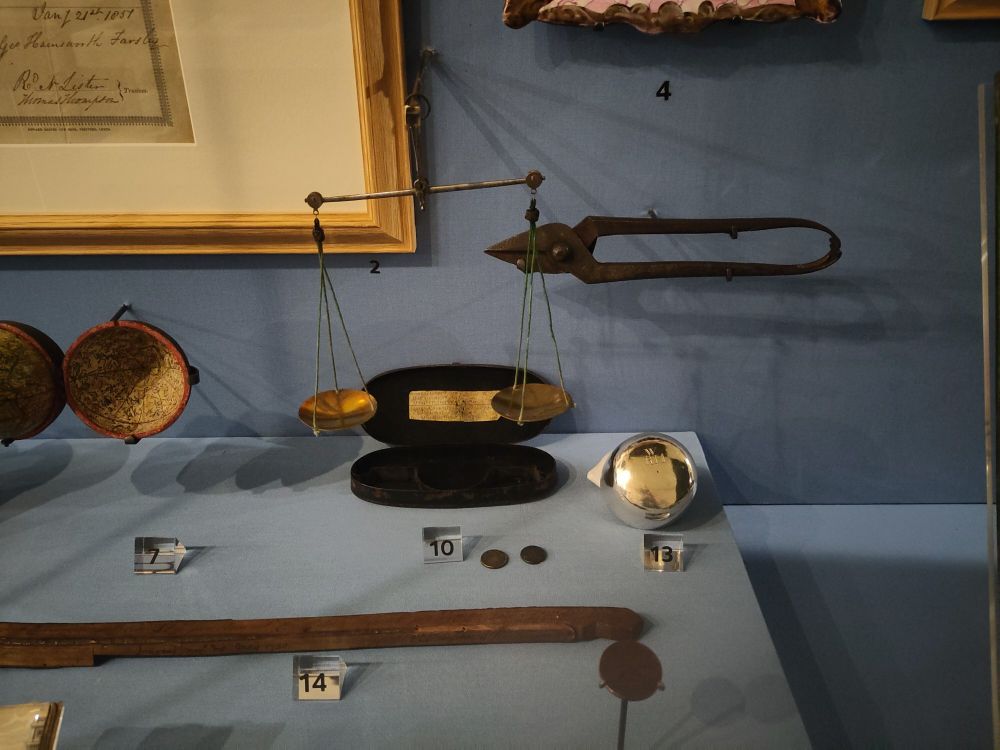 Leeds City Museum display including guinea balance 1772, Silver cup made by Arthur Mangey c1690 plus coin clipping shears found in the eaves of his house. 